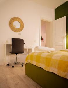 克卢日-纳波卡Smiling Apartment的一间卧室配有一张床、一张桌子和一把椅子