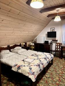 比亚沃维耶扎Leśne PoBudki的一间卧室设有一张床和木制天花板