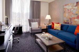 阿什维尔Renaissance Asheville Downtown Hotel的客厅配有蓝色的沙发和椅子