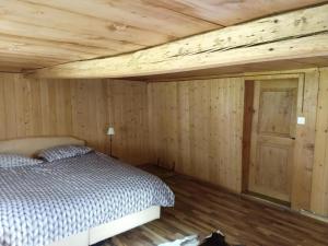 EngiGlärnisch Blick的一间卧室设有一张床和木制天花板