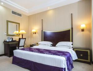 多哈旅客酒店的酒店客房设有一张大床和一张书桌。