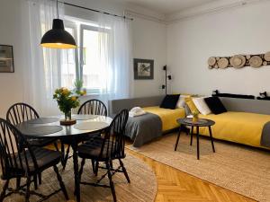 卢布尔雅那Boennium Apartments Green Oasis的一间带餐桌的客厅和一间卧室