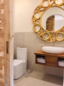 哲帕拉Belaya Hotel的浴室设有镜子、卫生间和水槽