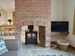 Barnby MoorCowslip - Uk13138的客厅设有砖砌壁炉及炉灶
