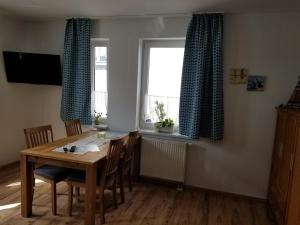 施特拉尔松德Altstadt Ferienwohnung Stralsund mit Parkplatz的一间带桌椅和窗户的用餐室