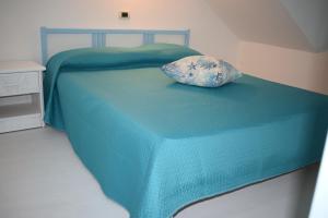 托雷坎内Chicca marina的一张蓝色的床,上面有枕头