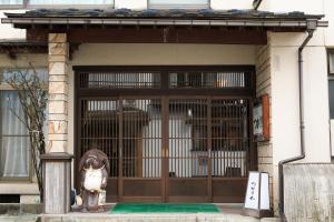 鹤冈市雅司旅馆的门前有狗雕像的门