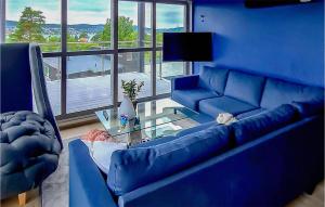 BrevikCozy Home In Brevik With House Sea View的蓝色的客厅配有蓝色的沙发和桌子