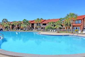 巴拿马城海滩Sandcastles and Sunshine - Gulf Highlands Beach Resort的棕榈树度假村的大型游泳池