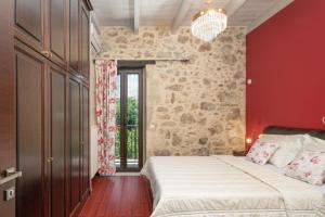 SívaVilla Lambraki的一间卧室设有一张大床和红色的墙壁