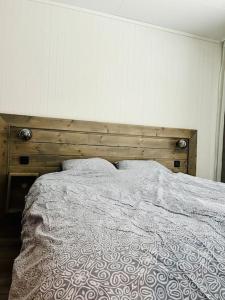 ElvegårdSkjomen Lodge的一张带木制床头板的床和两个枕头