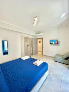 那不勒斯Apartment NAPOLI MARADONA的一张大蓝色的床,位于一个配有沙发的房间