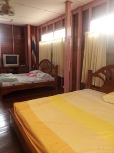 Ban Khok Sawang (2)นาหินลาดรีสอร์ท Nahinlad Resort的一间卧室配有两张床和电视。