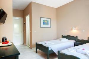 斯达林CorfuGrace的一间卧室设有两张床和一张带果盘的桌子。