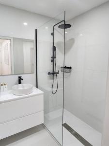 比索达雷加Janela D’Ouro的带淋浴和盥洗盆的白色浴室