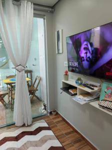 马瑙斯Casa Linda e Aconchegante的客厅配有壁挂式大屏幕平面电视