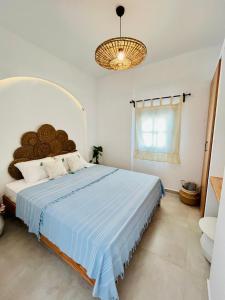 博德鲁姆Jakaranda Unique Apart的一间卧室配有一张带蓝色毯子的大床