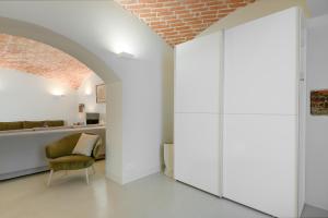 慕尼黑Exklusiv: Historisches Apartment mit Deckengewölbe的一间拥有白色墙壁和砖砌天花板的客房