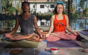 鲁滕Ara Garden Inn, Accommodation, Yoga studio & Spa的坐在瑜伽中的一个男人和一个女人