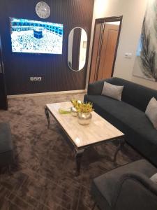 吉赞Aseel Hotel Apartment的客厅配有沙发和桌子