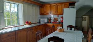 FolgosinhoQuinta da Barbosa的厨房配有木制橱柜和白色冰箱。