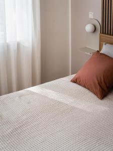 马尔肖HORAMI Villa - ORIGAMI Apartment mit Terrasse的一间卧室配有一张红色枕头的床