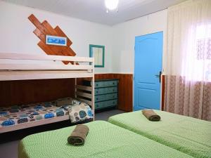La MaretaHostel Blue Lagoon的一间卧室设有两张双层床和一扇蓝色的门