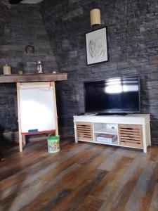 Mareny BarraquetasLa Caseta de Jose的一间带电视和砖墙的客厅