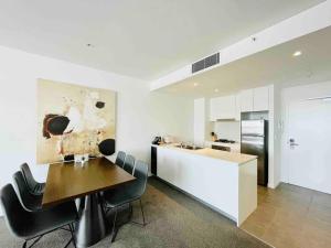 悉尼Sydney Executive Apartment 3beds2baths parking Chatswood的厨房以及带桌椅的用餐室。