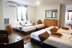 Kampong Sum Sum101 Resort & Spa, Janda Baik的带四张床和镜子的客房