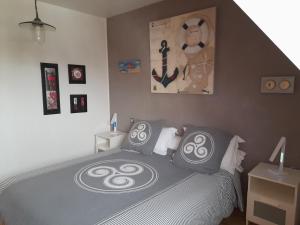TrégourezKermarco的一间卧室配有一张带黑白枕头的床