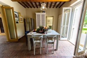 SantʼAnsanoCasa Betta的厨房配有桌椅和冰箱。