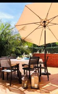 圣维森特-德拉巴尔克拉Apartamentos Costa Norte的庭院内桌椅和遮阳伞