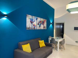 滨海波利尼亚诺Casa Margherita Stefy - locazione turistica的带沙发和蓝色墙壁的客厅