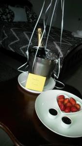 拉罗马纳Hotel Boutique Simona的一张桌子,上面放着两盘草莓和一碗酱