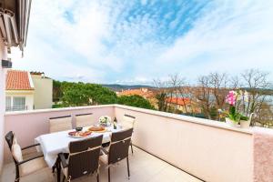 索利纳Apartment Porto Vito的设有一个配有桌椅并享有美景的阳台。