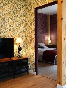 Bergholtz-ZellL'Atelier des Ombelles的客房设有带一张床和镜子的卧室
