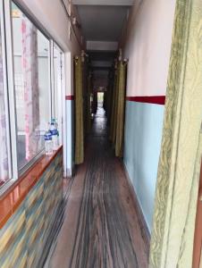 西里古里Bikash Bhawan Lodge的走廊,建筑的走廊,有长地板和窗户