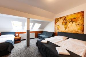 布拉格哲拉塔瓦哈酒店的一间卧室设有两张床,墙上挂着一幅画
