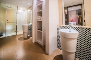 台北Artinn藝築文旅-台北站前館的浴室设有2个卫生间和水槽