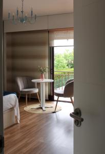 巴约讷Altos de Baiona - Habitación privada的客房设有桌椅和阳台。