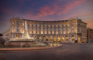 罗马Anantara Palazzo Naiadi Rome Hotel - A Leading Hotel of the World的一座大型建筑,前面有一个喷泉