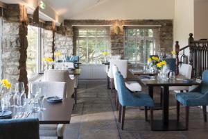 艾斯加斯Aysgarth Falls Hotel & Restaurant的用餐室设有桌椅和窗户。