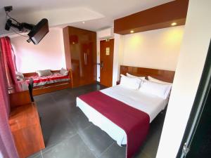 纳扎雷Hotel Oceano的一间卧室配有一张带红色毯子的大床
