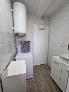 皮罗特N&M Apartment的白色的浴室设有水槽和卫生间。