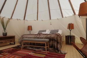 胡迪克斯瓦尔Hölick Havsresort & spa的帐篷内一间卧室,配有一张床