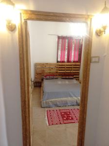 托泽尔Dar Chahla的卧室的镜子反射,卧室配有一张床