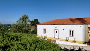 奥比多斯Quinta do Oratório Agroturismo的白色房子,有红色屋顶