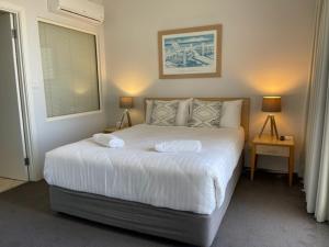 茶园船屋豪华公寓的卧室配有一张带两个枕头的大白色床
