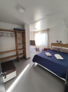 巴尼奥斯Elegante apartamento con vistas al volcán Tungurahua的一间卧室设有蓝色的床和窗户。
